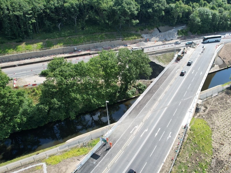 Traffic using the new bridge across the canal. Construction work is in progress next to the A629 in the background.